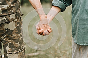 Happy senior couple holding hands. hands of man and woman hold each other. romance and love and support in elderly family. faceles