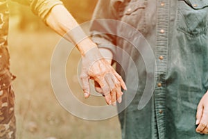 happy senior couple holding hands. hands of man and woman hold each other. romance and love and support in elderly family. faceles