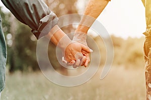 happy senior couple holding hands. hands of man and woman hold each other. romance and love and support in elderly family. faceles