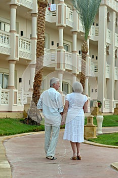 Happy senior couple at hotel resort posing