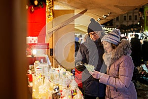 Happy senior couple hugging at christmas market