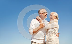 Happy senior couple hugging outdoors