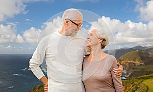 Happy senior couple hugging over big sur coast