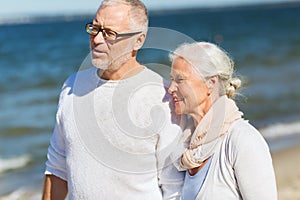 Happy senior couple hugging on summer beach