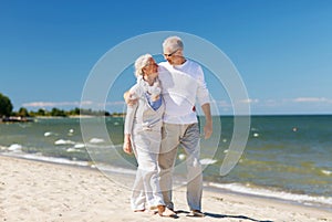 Happy senior couple hugging on summer beach