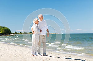 Happy senior couple hugging on summer beach