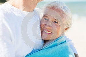 Happy senior couple hugging on summer beach