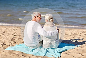 Happy senior couple hugging on summer beach