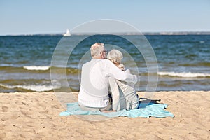 Happy senior couple hugging on summer beach