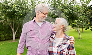 Happy senior couple hugging at summer garden