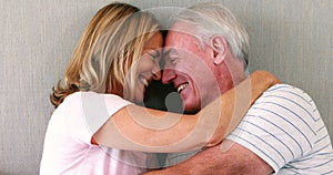 Happy senior couple interacting with each other on bed