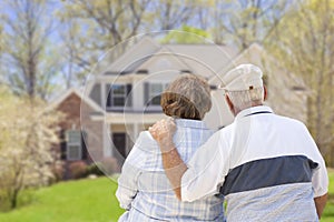 Happy Senior Couple Looking at Front of House photo