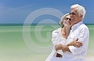 Happy Senior Couple Looking To Sea on Beach