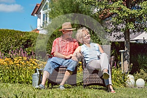 Happy senior couple in love relaxing together in the garden in a