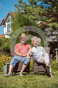 Happy senior couple in love relaxing together in the garden