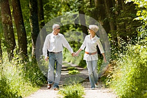 Happy senior couple outdoors running