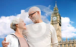 Happy senior couple over big ben tower in london