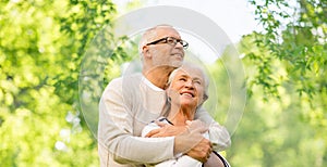 Happy senior couple over green natural background