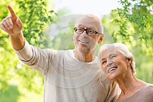 Happy senior couple over green natural background