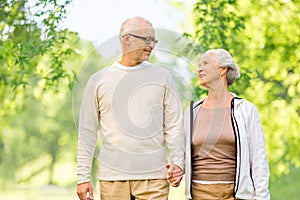 Happy senior couple over green natural background