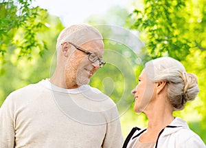 Happy senior couple over green natural background