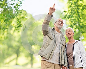 Happy senior couple over green natural background