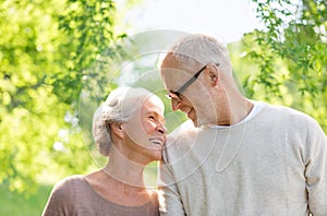 Happy senior couple over green natural background