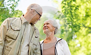 Happy senior couple over green natural background