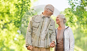 Happy senior couple over green natural background