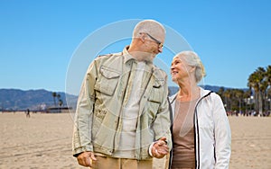 Happy senior couple over venice beach background
