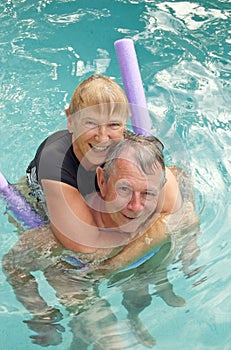 Happy senior couple in pool