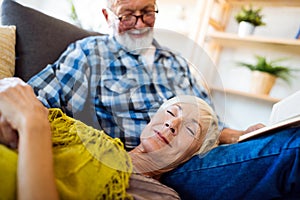 Happy senior couple relaxing at home together