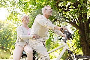 Happy senior couple riding on bicycle at park