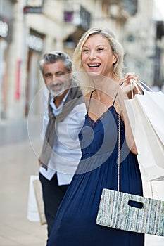 happy senior couple shopping together