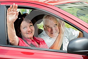 Happy Senior Couple Sitting Inside Car