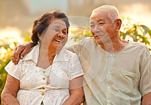 Happy Senior couple sitting outdoors