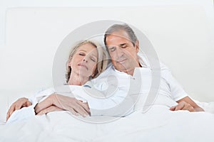 Happy Senior Couple On Sleeping Bed