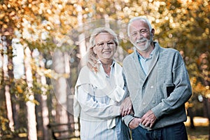 Happy senior couple smiling outdoors in nature