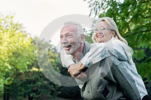 Happy senior couple smiling outdoors in nature