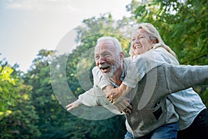 Happy senior couple smiling outdoors in nature photo