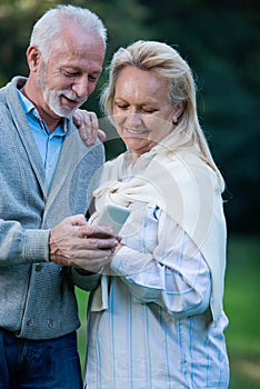 Happy senior couple smiling outdoors in nature