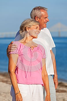 Happy Senior Couple Standing Embracing on a Beach