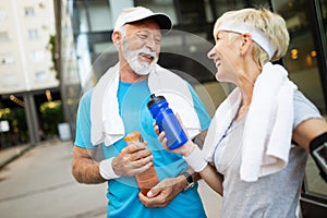 Happy senior couple staying fit by sport running