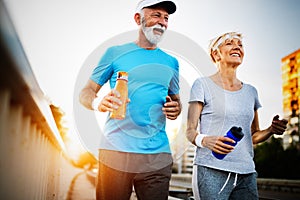 Happy senior couple staying fit by sport running