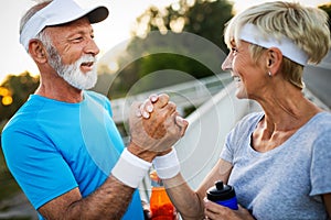 Happy senior couple staying fit by sport running