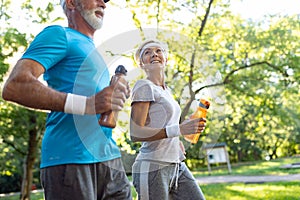 Happy senior couple staying fit by sport running