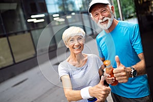 Happy senior couple staying fit by sport running