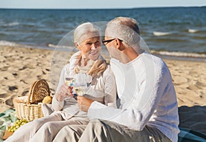 Happy senior couple talking on summer beach