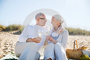 Happy senior couple talking on summer beach