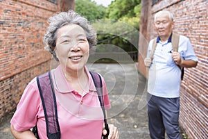 Happy senior couple tourists outdoors in historic town